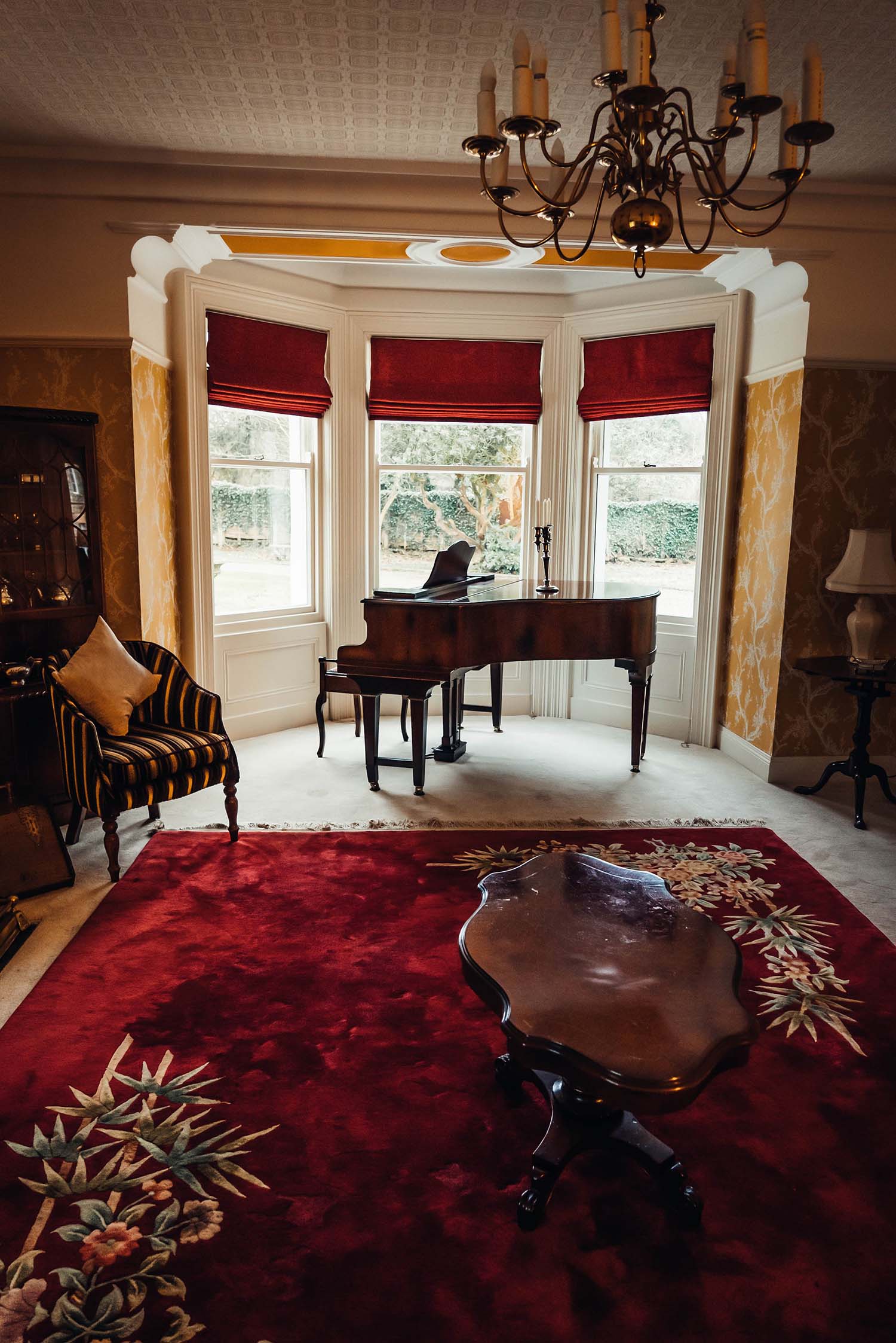 Traditional Red rug in the Piano Room